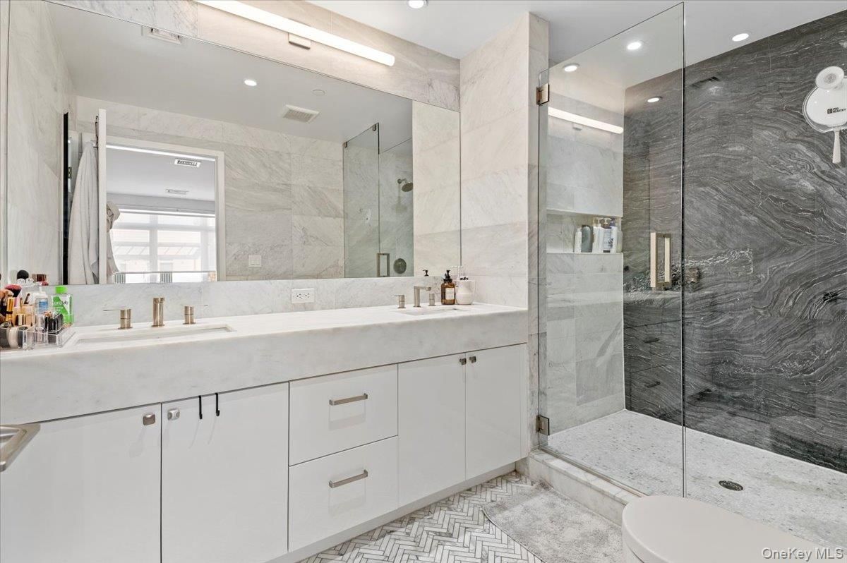 Bathroom, Dual Sink Vanities, Glass Shower, Interior, Marble Walls, Recessed Lighting