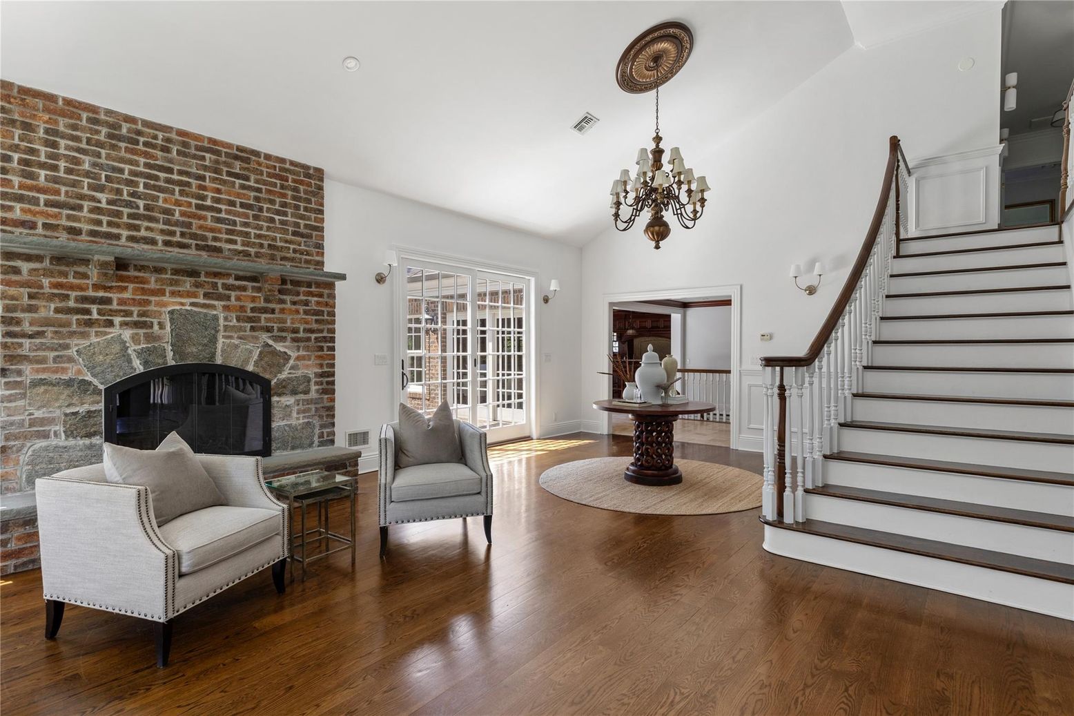 Chandelier, Fireplace, Interior, Recessed Lighting, Stone Walls, Wood Texture Flooring