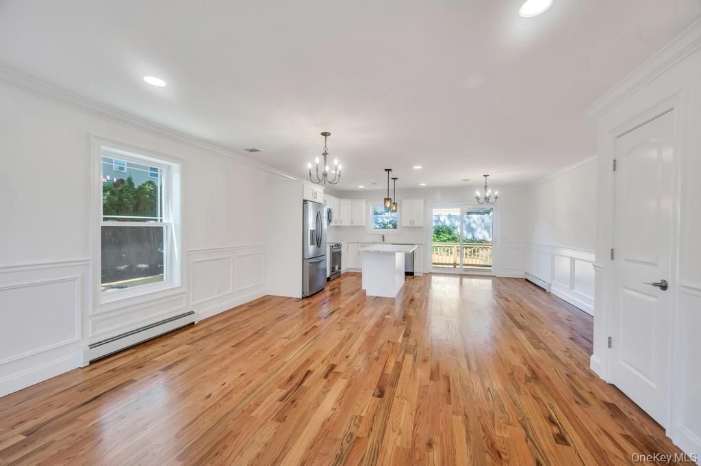 Chandelier, Empty room, Interior, Kitchen, Pendant Lights, Recessed Lighting, Stainless Steel Appliances, Wood Texture Flooring