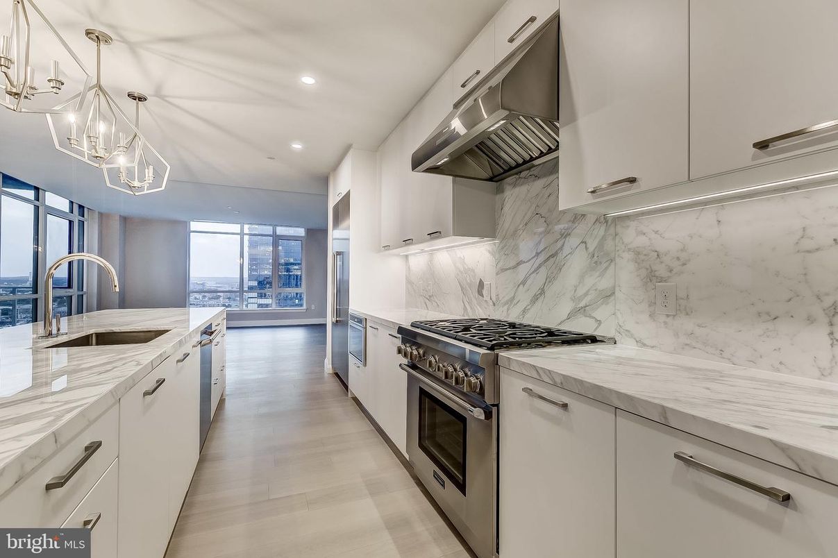 Chandelier, Interior, Kitchen, Marble Walls, Pendant Lights, Recessed Lighting, Stainless Steel Appliances, Wood Texture Flooring