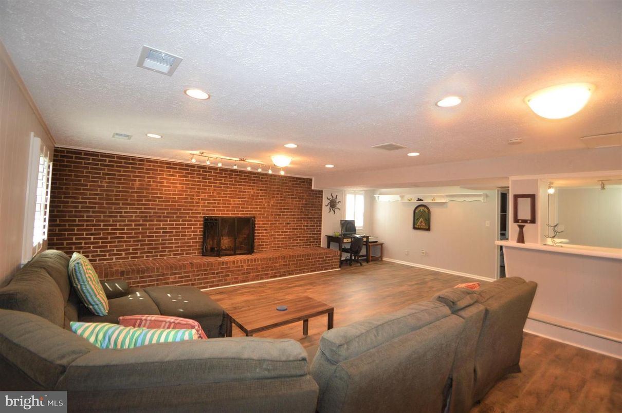 Fireplace, Interior, Living room, Recessed Lighting, Stone Walls, Wood Texture Flooring