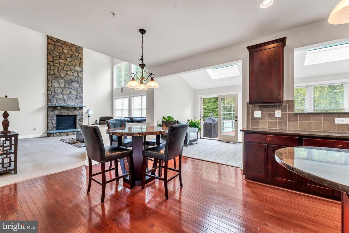 Dining room, Fireplace, Interior, Pendant Lights, Recessed Lighting, Stone Walls, Wood Texture Flooring