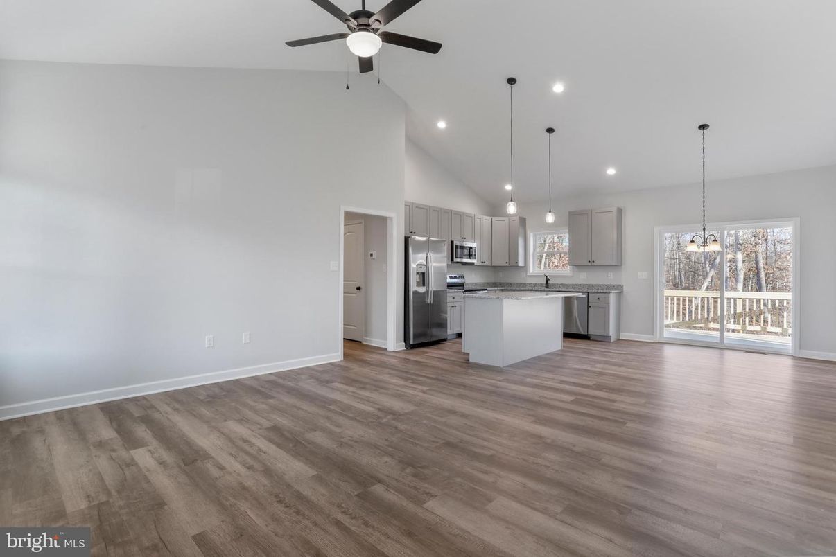 Empty room, Interior, Kitchen, Pendant Lights, Recessed Lighting, Stainless Steel Appliances, Wood Texture Flooring