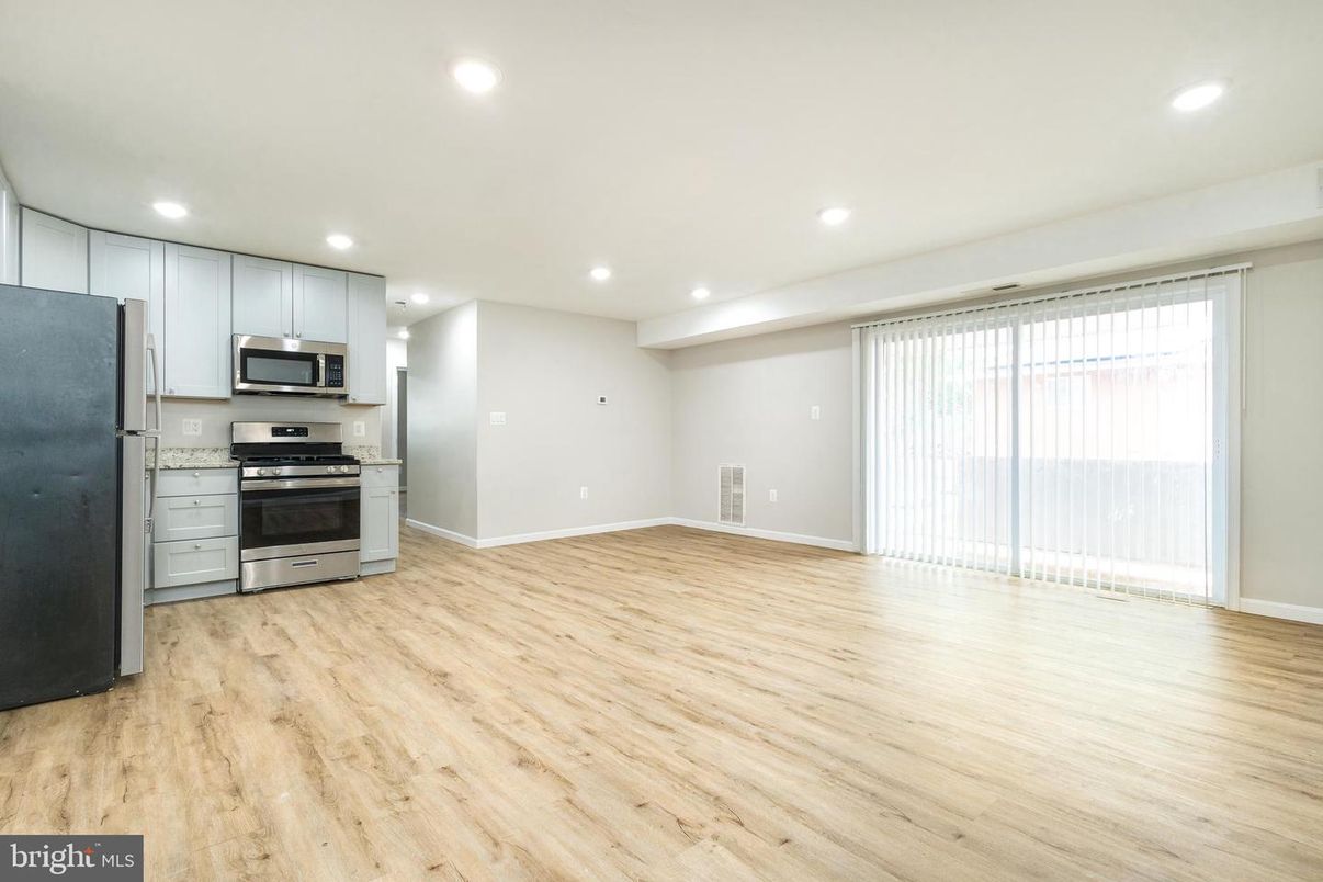 Empty room, Interior, Kitchen, Recessed Lighting, Stainless Steel Appliances, Wood Texture Flooring