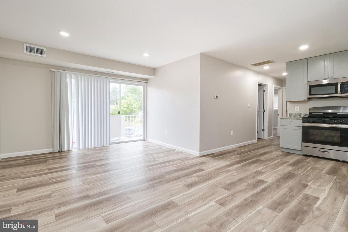 Empty room, Interior, Kitchen, Recessed Lighting, Stainless Steel Appliances, Wood Texture Flooring