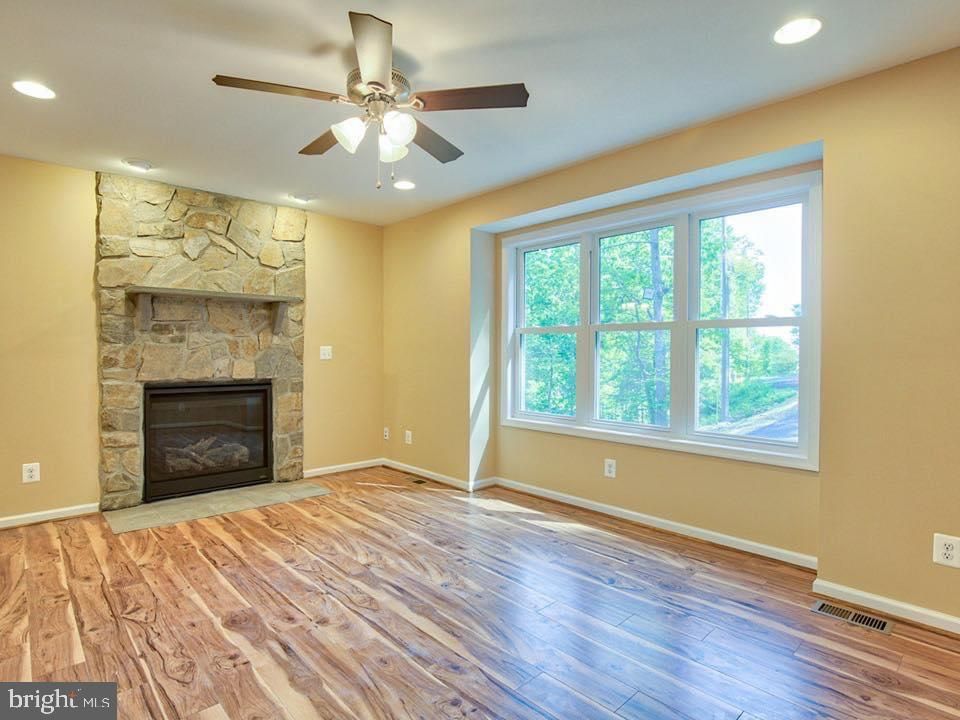 Empty room, Fireplace, Interior, Recessed Lighting, Stone Walls, Wood Texture Flooring