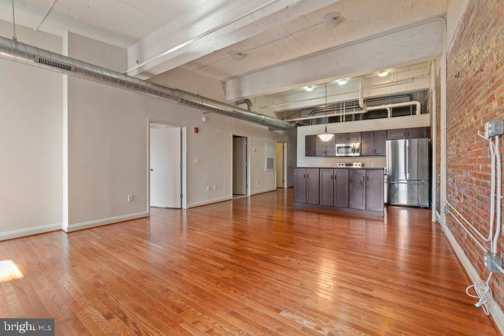 Empty room, Interior, Kitchen, Pendant Lights, Stainless Steel Appliances, Stone Walls, Wood Texture Flooring