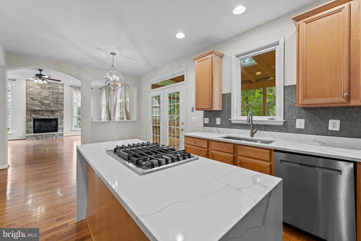 Chandelier, Fireplace, Interior, Kitchen, Recessed Lighting, Stone Walls, Wood Texture Flooring