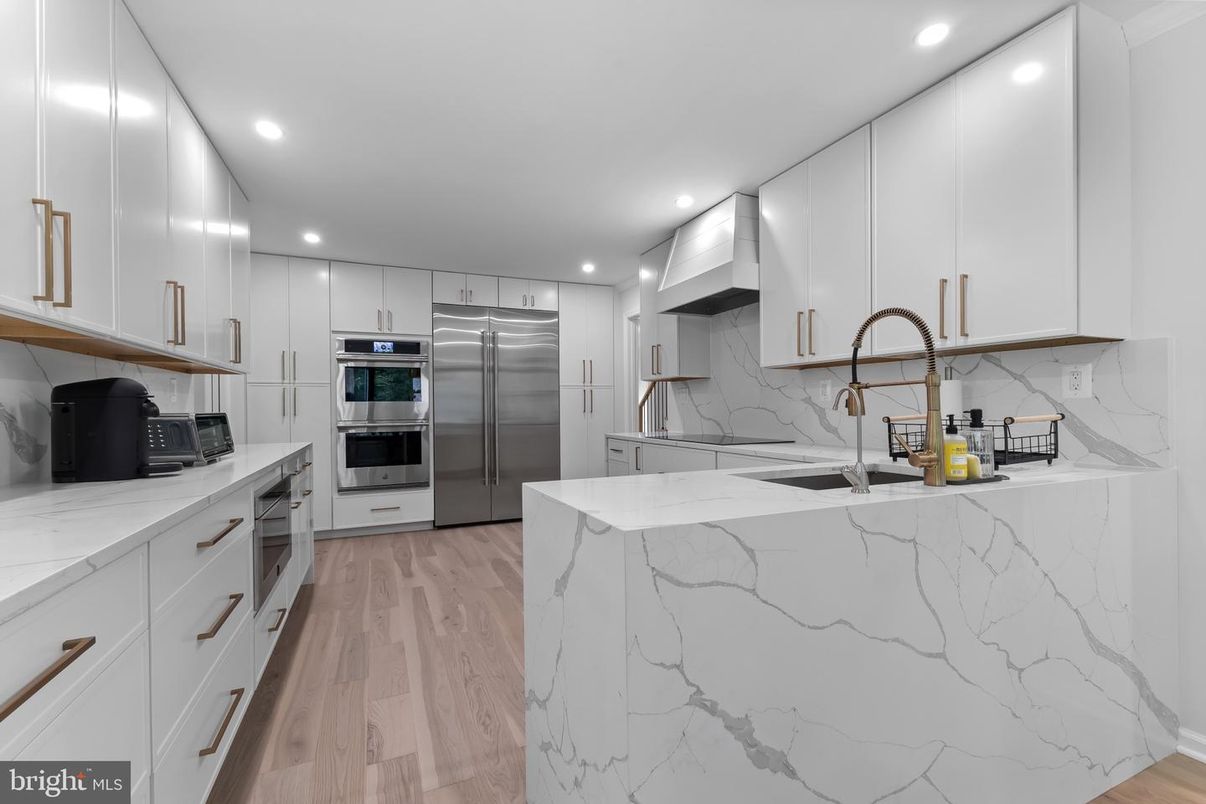 Interior, Kitchen, Marble Walls, Recessed Lighting, Stainless Steel Appliances, Wood Texture Flooring
