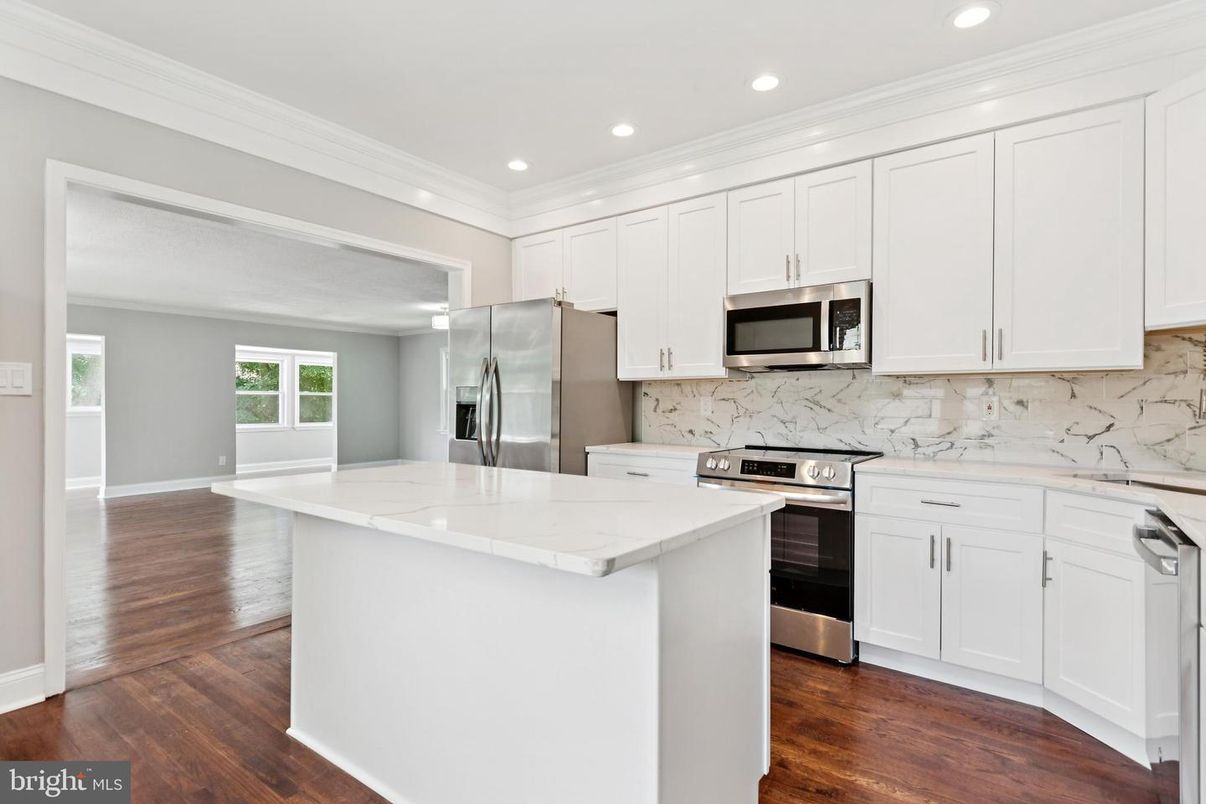 Interior, Kitchen, Marble Walls, Recessed Lighting, Stainless Steel Appliances, Wood Texture Flooring