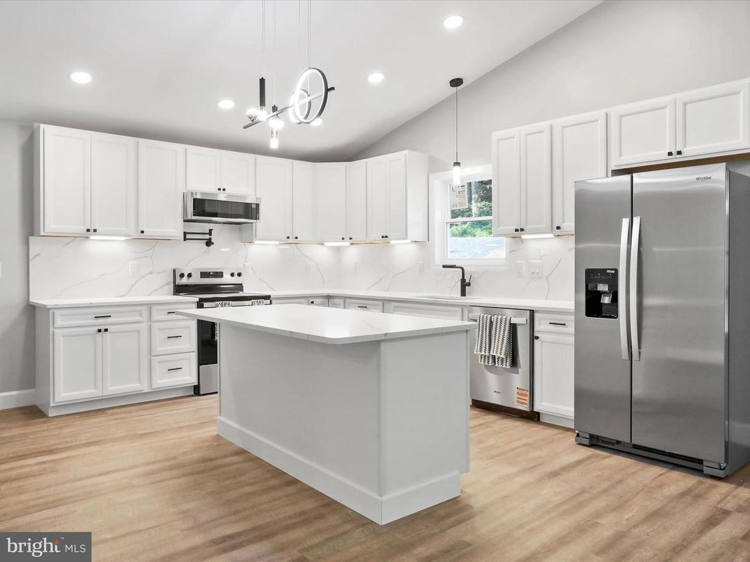 Interior, Kitchen, Marble Walls, Pendant Lights, Recessed Lighting, Stainless Steel Appliances, Wood Texture Flooring