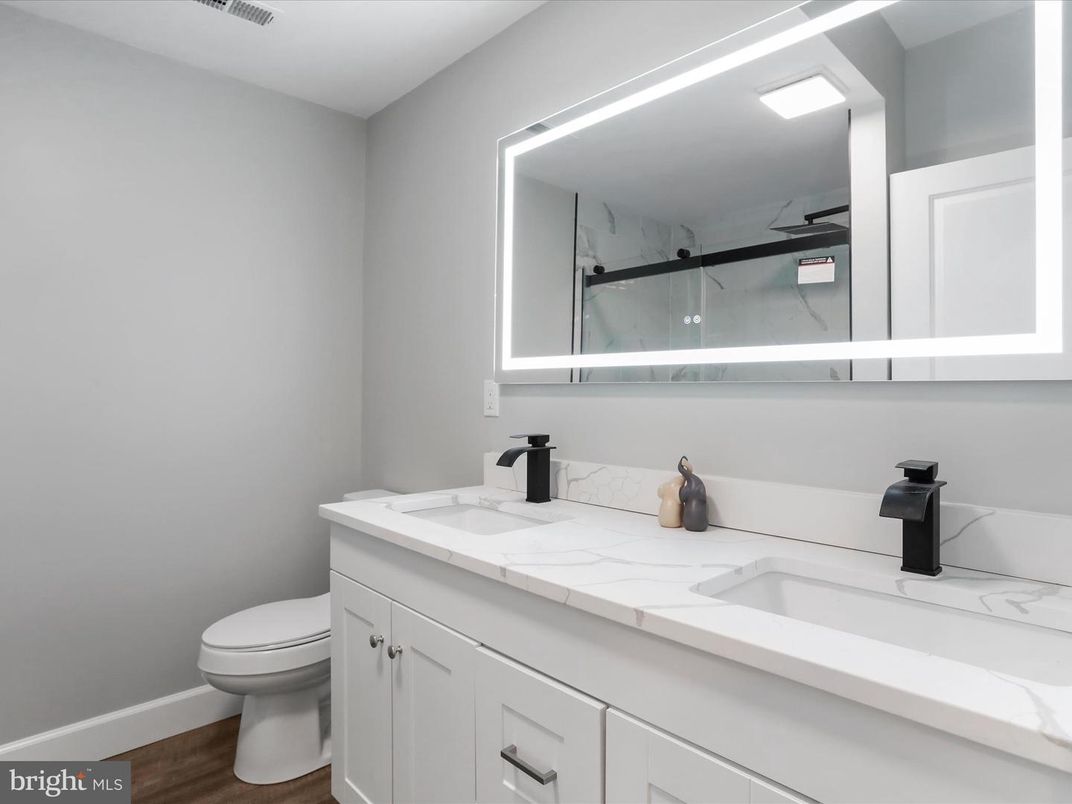 Bathroom, Dual Sink Vanities, Interior, Marble Walls, Tile Countertops, Wood Texture Flooring
