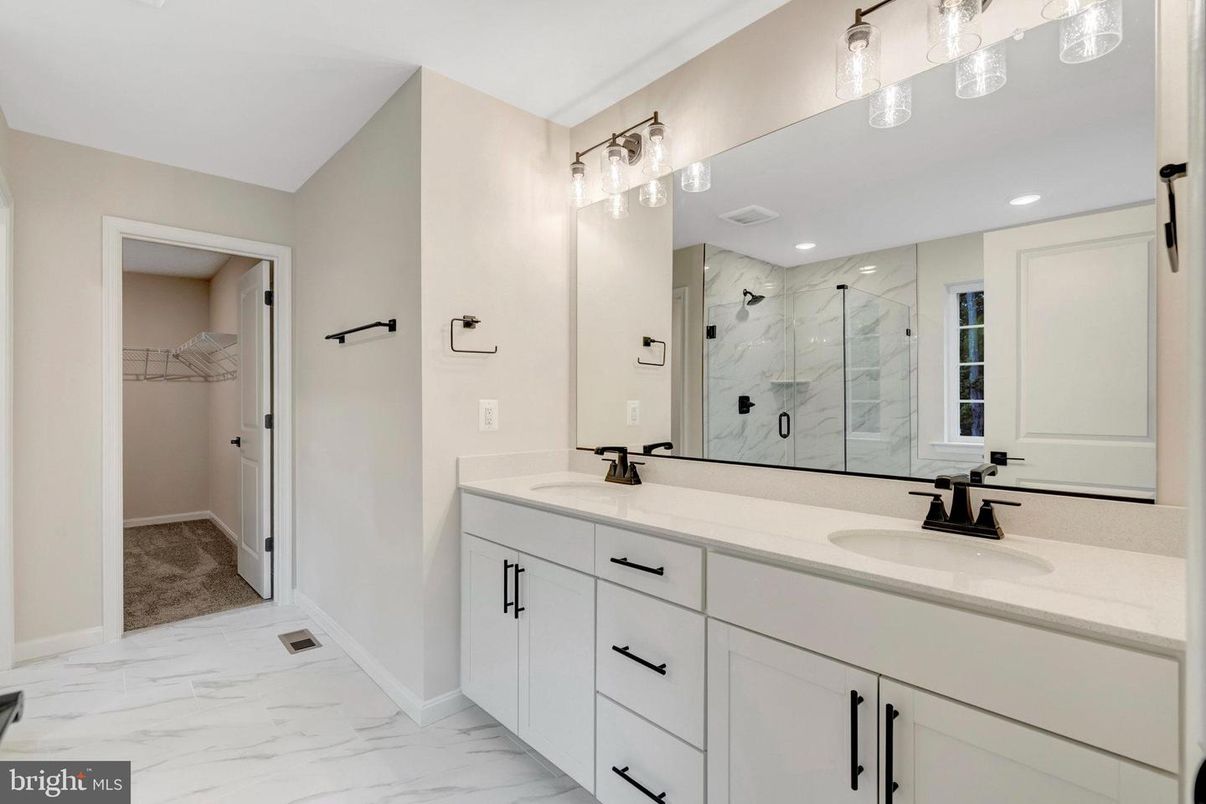 Bathroom, Dual Sink Vanities, Glass Shower, Interior, Marble, Recessed Lighting, Walk-in Closets