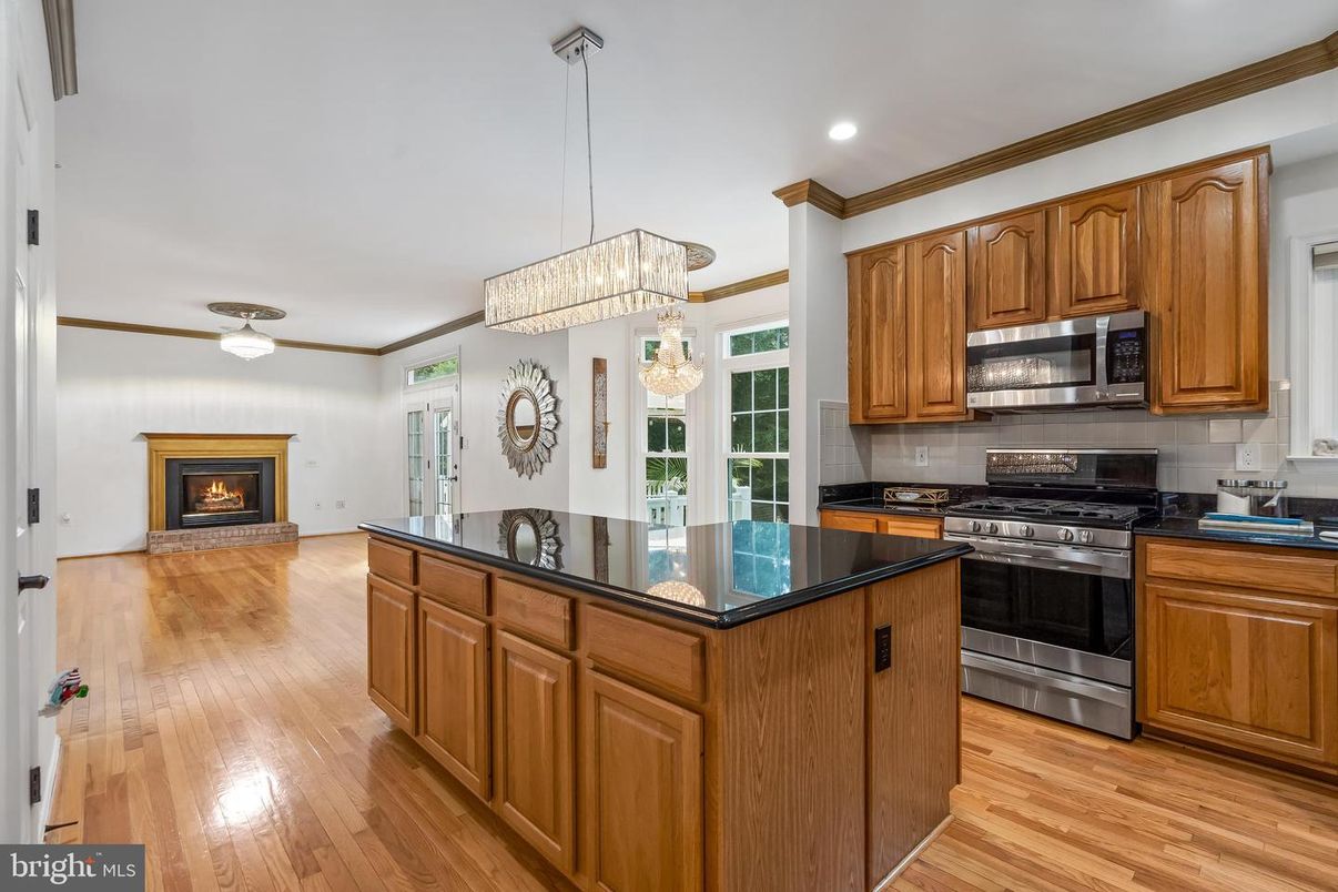 Chandelier, Fireplace, Interior, Kitchen, Pendant Lights, Recessed Lighting, Stainless Steel Appliances, Wood Texture Flooring