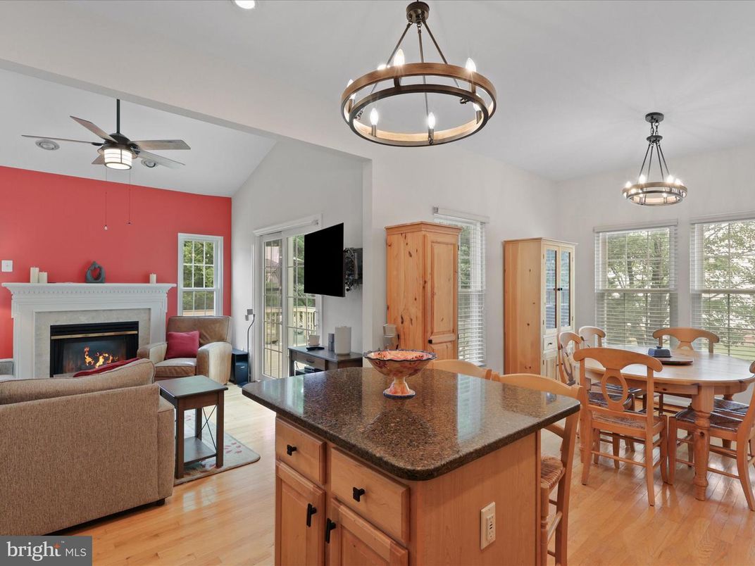 Chandelier, Dining room, Fireplace, Interior, Living room, Pendant Lights, Recessed Lighting, Wood Texture Flooring