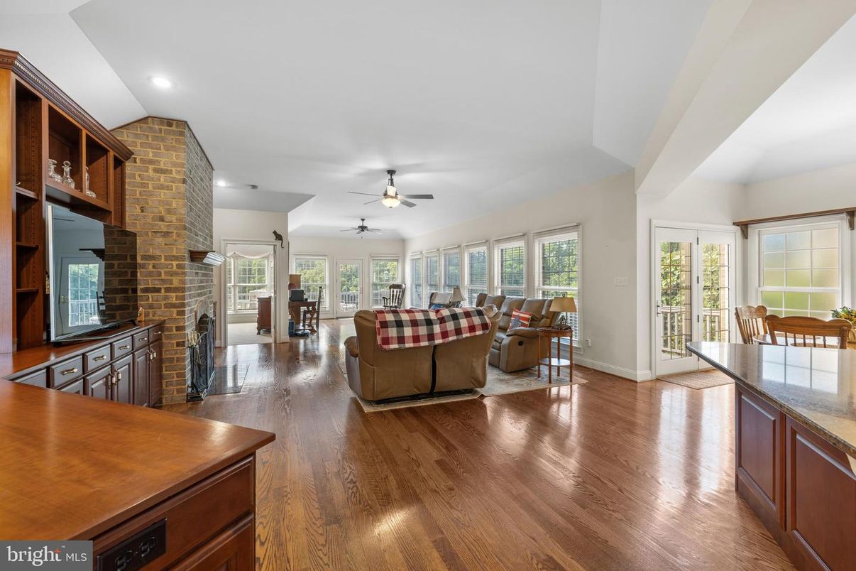 Dining room, Fireplace, Interior, Living room, Recessed Lighting, Stone Walls, Wood Texture Flooring