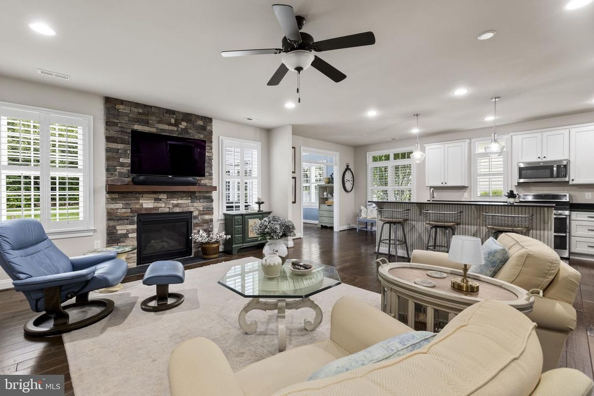 Fireplace, Interior, Kitchen, Living room, Pendant Lights, Recessed Lighting, Stainless Steel Appliances, Stone Walls, Wood Texture Flooring