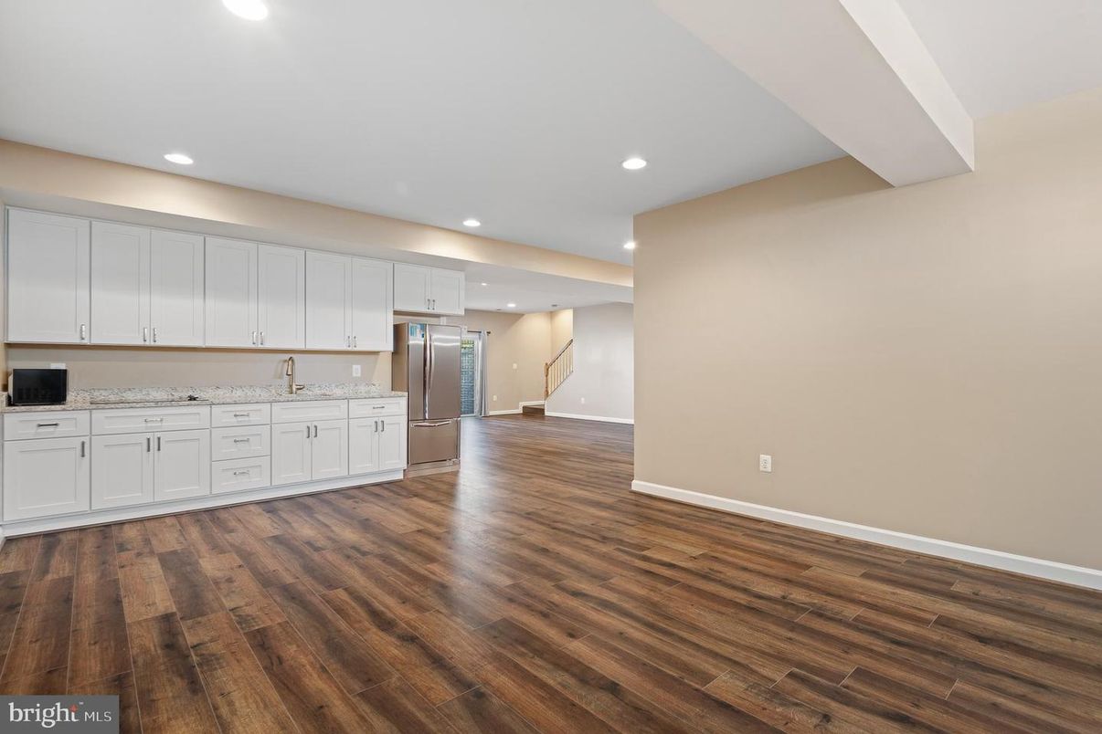 Empty room, Interior, Kitchen, Recessed Lighting, Stainless Steel Appliances, Wood Texture Flooring