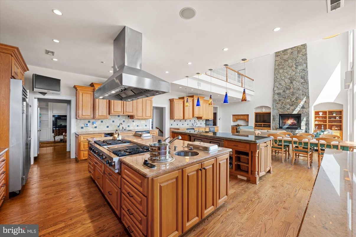 Dining room, Fireplace, Interior, Kitchen, Pendant Lights, Recessed Lighting, Stainless Steel Appliances, Stone Walls, Wood Texture Flooring