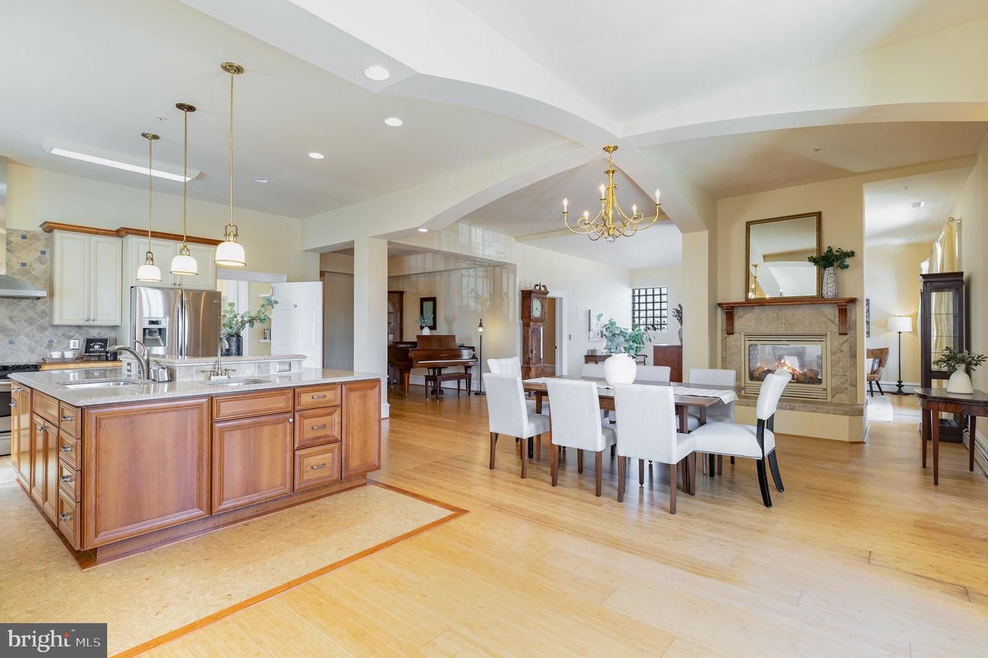 Chandelier, Dining room, Fireplace, Interior, Kitchen, Pendant Lights, Recessed Lighting, Stainless Steel Appliances, Wood Texture Flooring