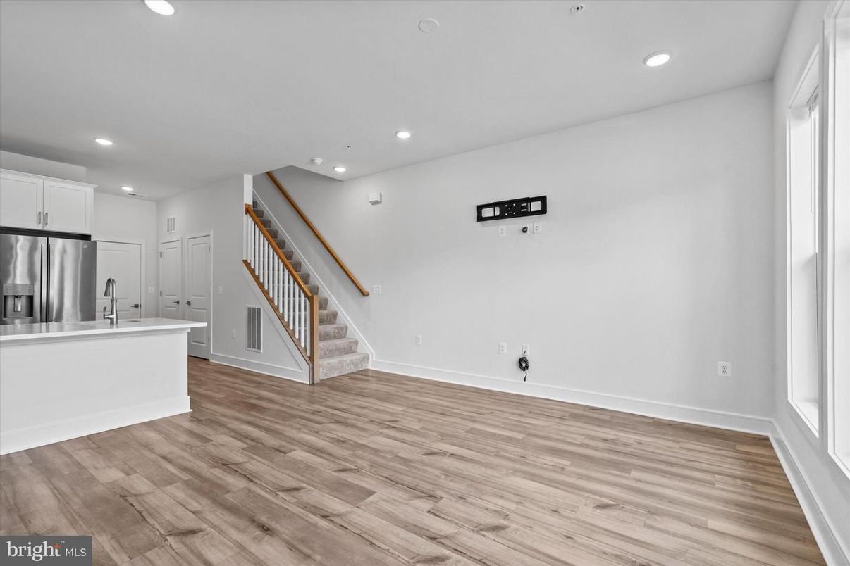 Empty room, Interior, Kitchen, Recessed Lighting, Stainless Steel Appliances, Wood Texture Flooring