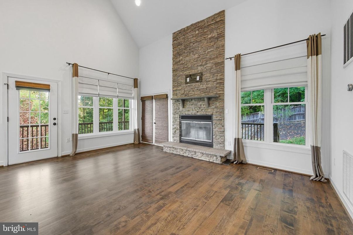 Empty room, Fireplace, Interior, Recessed Lighting, Stone Walls, Wood Texture Flooring