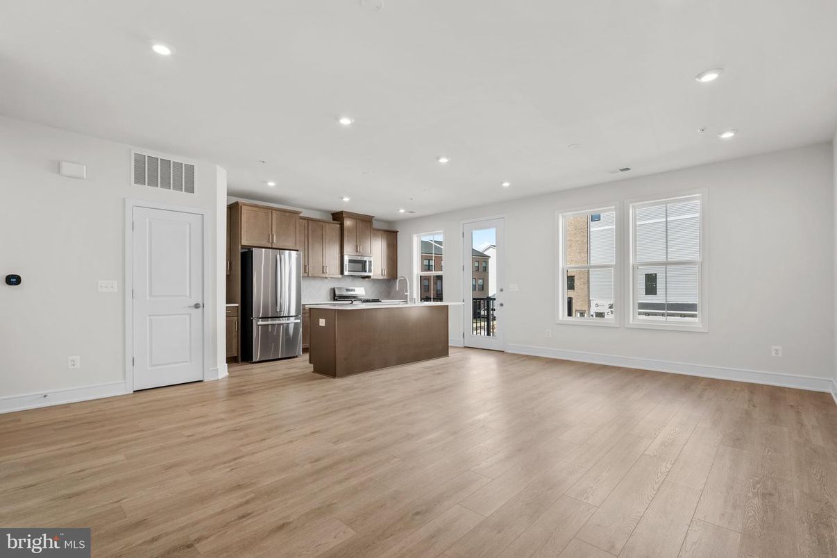 Empty room, Interior, Kitchen, Recessed Lighting, Stainless Steel Appliances, Wood Texture Flooring