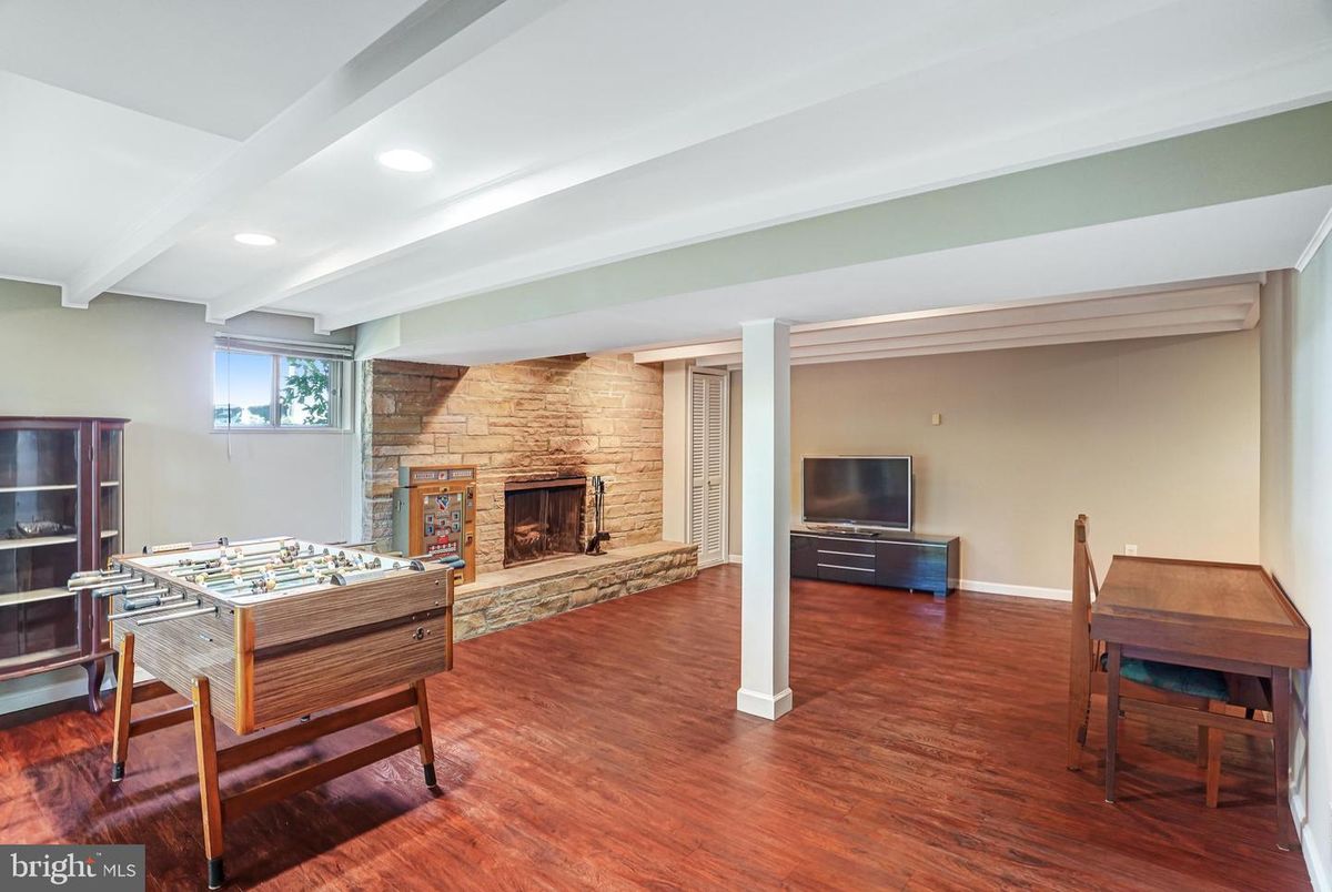 Fireplace, Game Room, Interior, Recessed Lighting, Stone Walls, Wood Texture Flooring