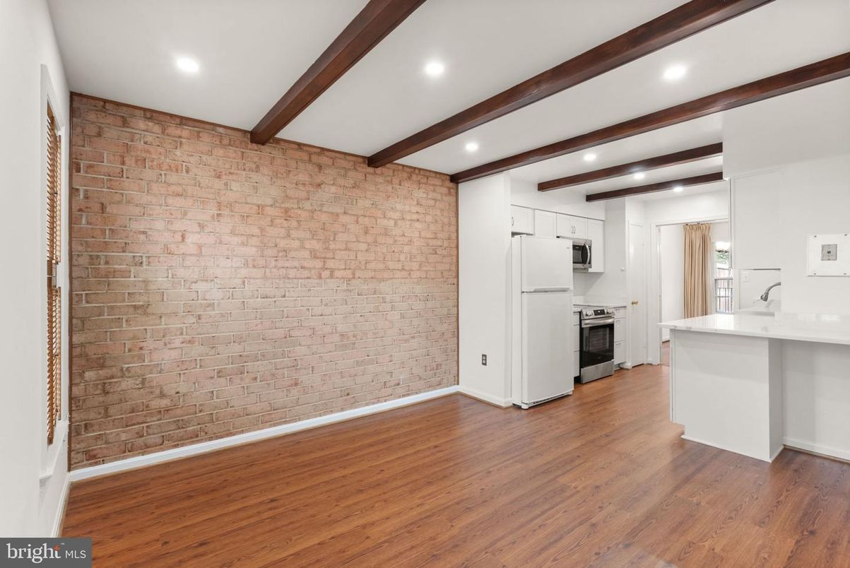 Empty room, Interior, Kitchen, Recessed Lighting, Stainless Steel Appliances, Stone Walls, Wooden Beams, Wood Texture Flooring