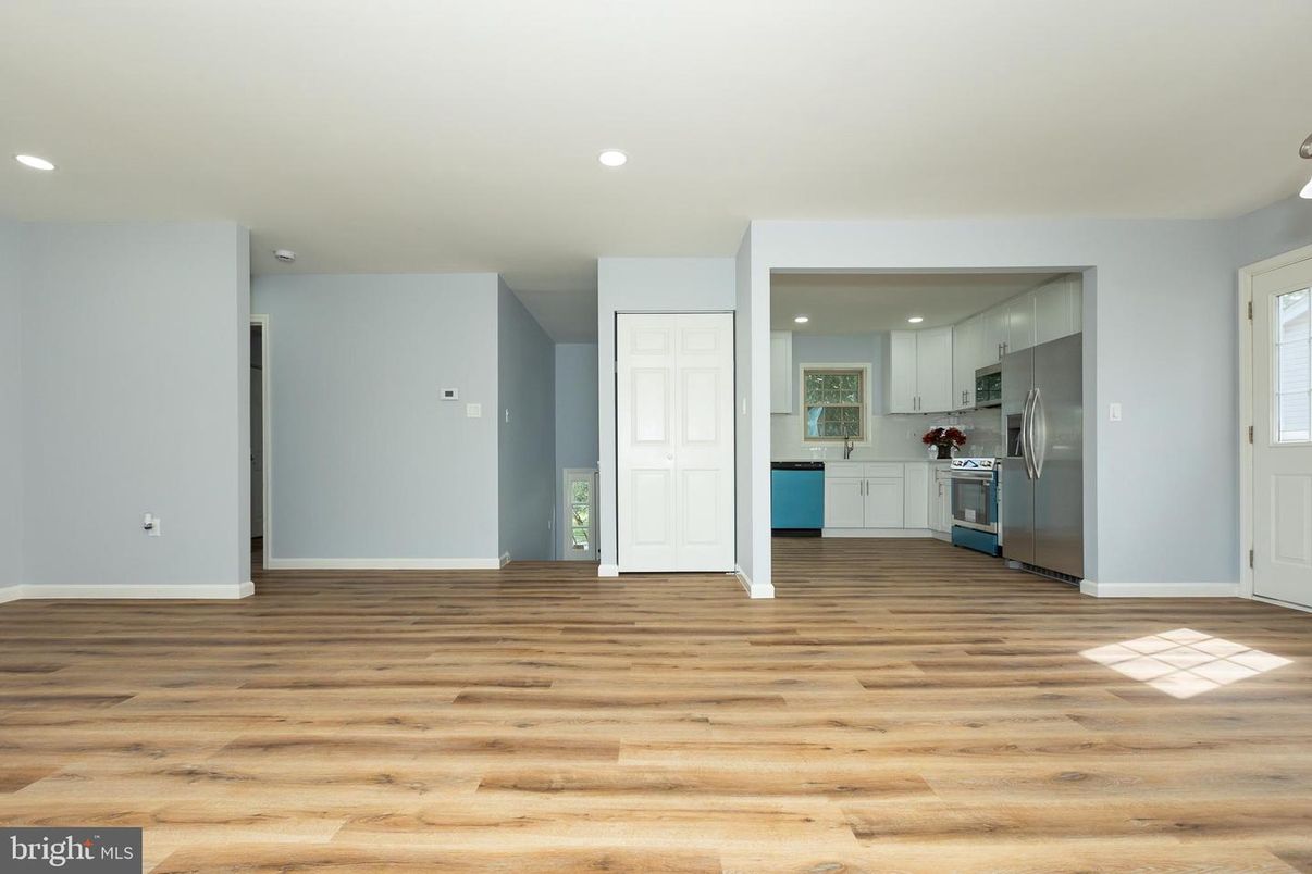 Empty room, Interior, Kitchen, Recessed Lighting, Stainless Steel Appliances, Wood Texture Flooring