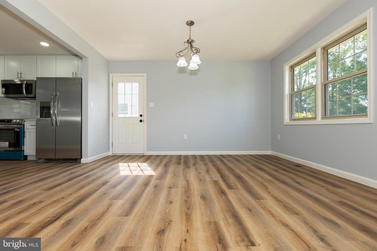 Empty room, Interior, Kitchen, Pendant Lights, Recessed Lighting, Stainless Steel Appliances, Wood Texture Flooring