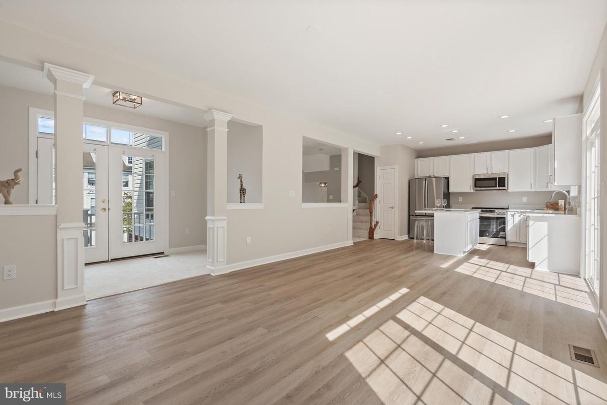 Empty room, Interior, Kitchen, Recessed Lighting, Stainless Steel Appliances, Wood Texture Flooring
