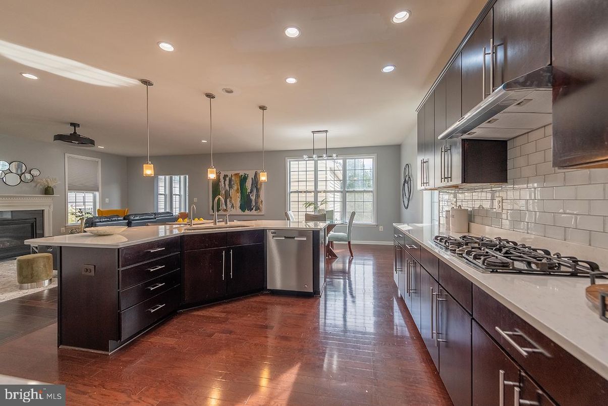 Dining room, Fireplace, Interior, Kitchen, Pendant Lights, Recessed Lighting, Stainless Steel Appliances, Wood Texture Flooring