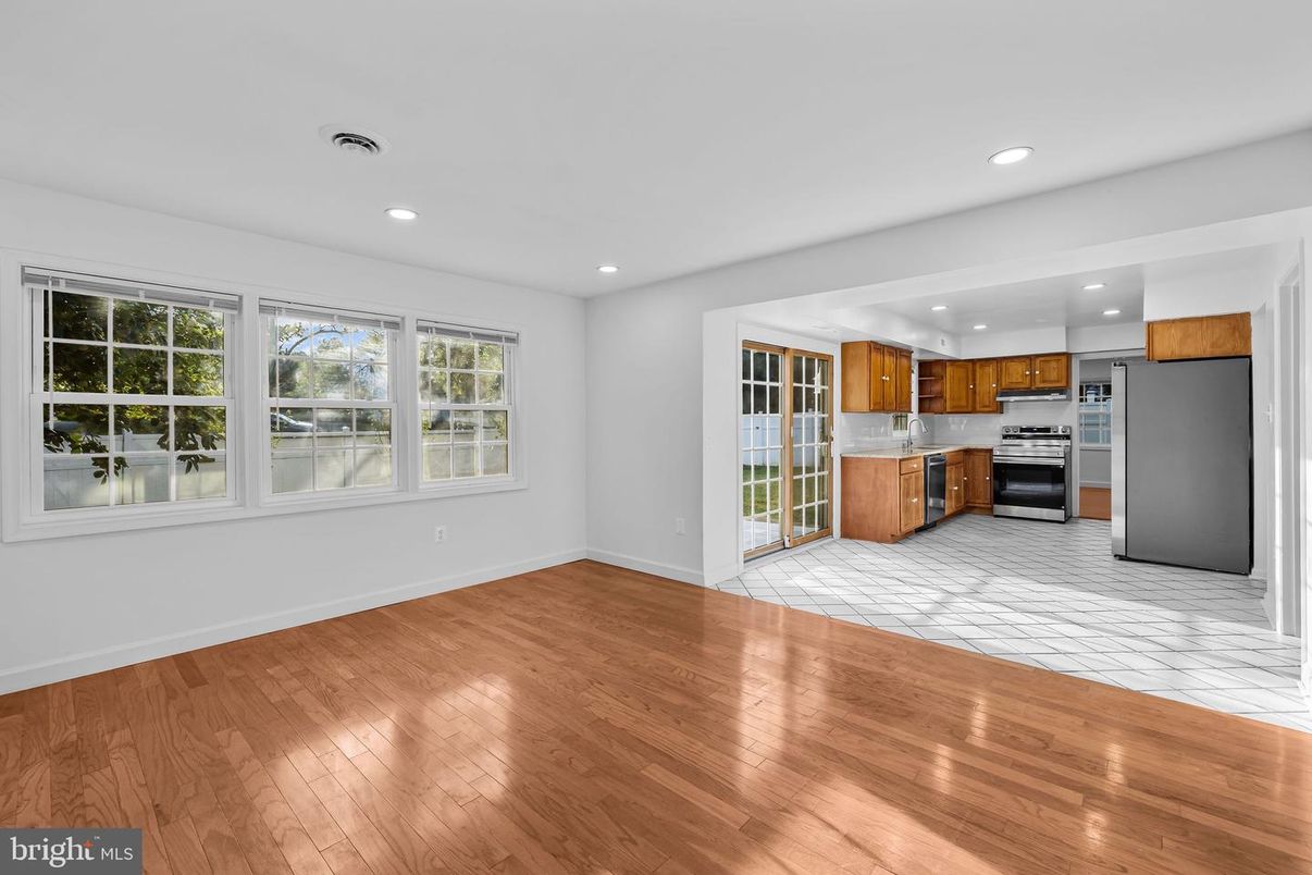 Empty room, Interior, Kitchen, Recessed Lighting, Stainless Steel Appliances, Wood Texture Flooring