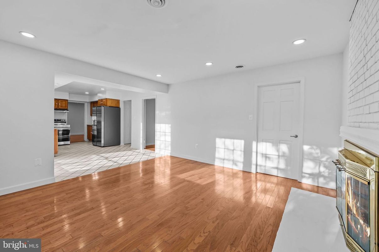 Empty room, Interior, Kitchen, Recessed Lighting, Stainless Steel Appliances, Wood Texture Flooring