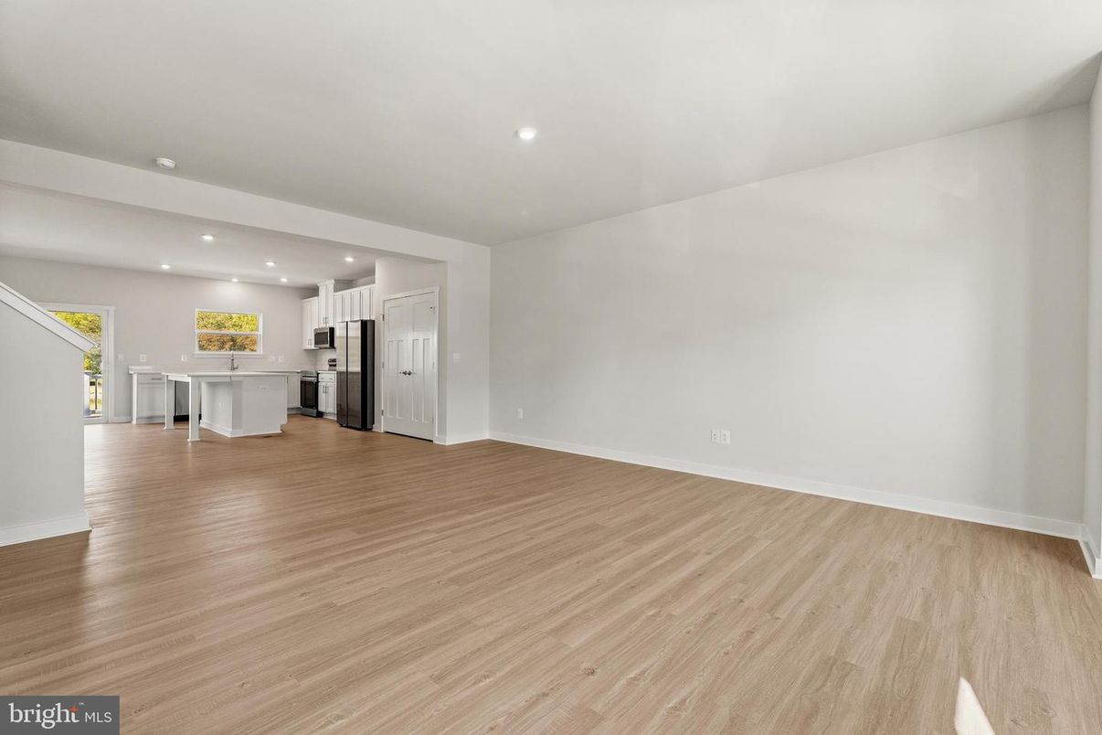 Empty room, Interior, Kitchen, Recessed Lighting, Stainless Steel Appliances, Wood Texture Flooring
