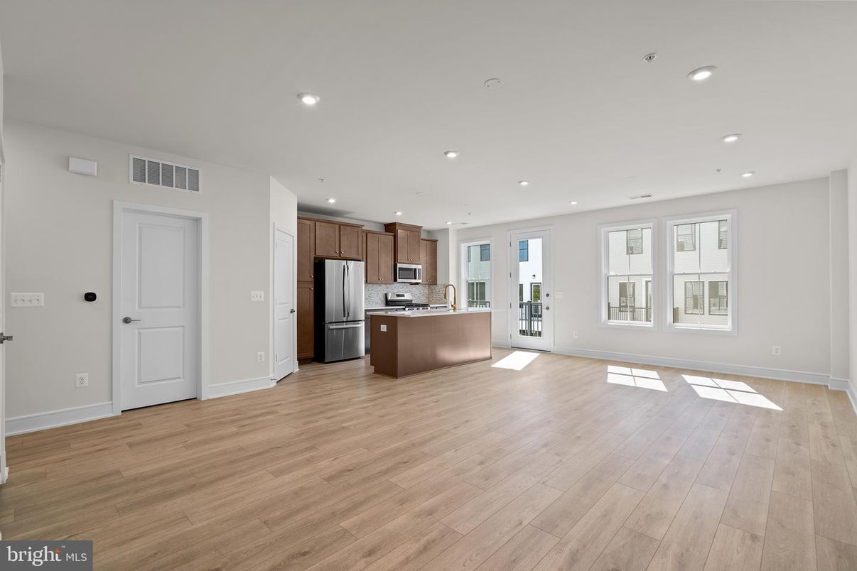Empty room, Interior, Kitchen, Recessed Lighting, Stainless Steel Appliances, Wood Texture Flooring