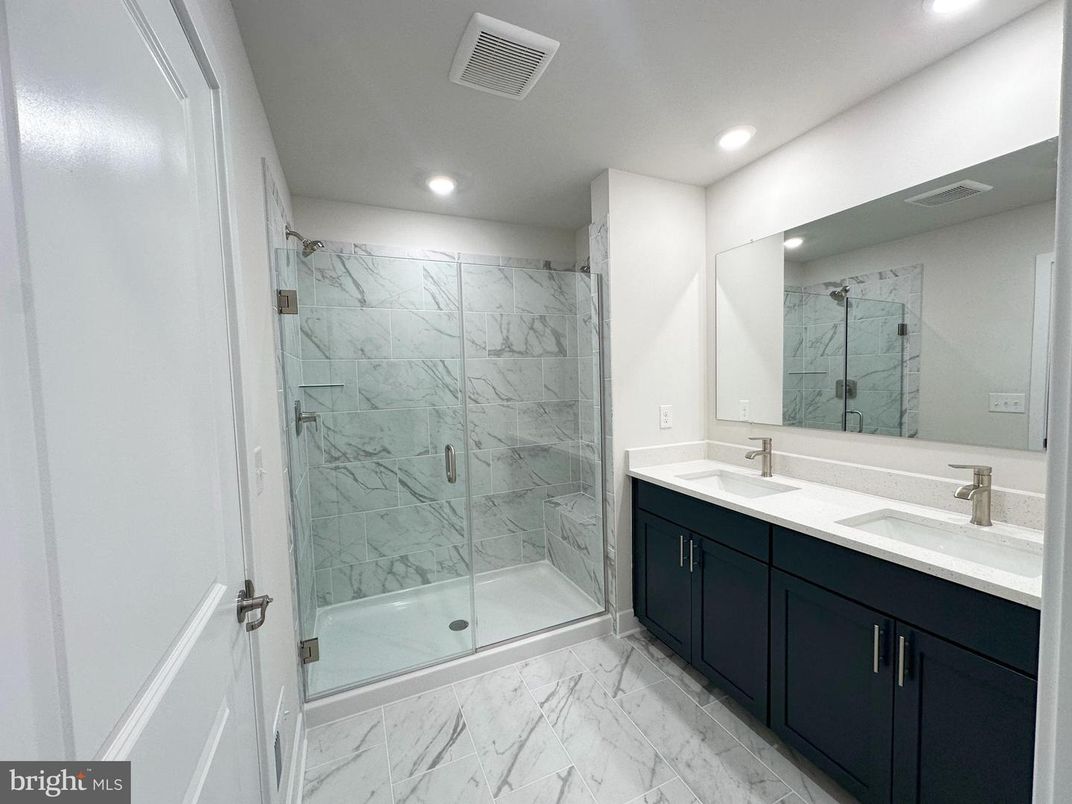 Bathroom, Dual Sink Vanities, Glass Shower, Interior, Marble, Marble Walls, Recessed Lighting