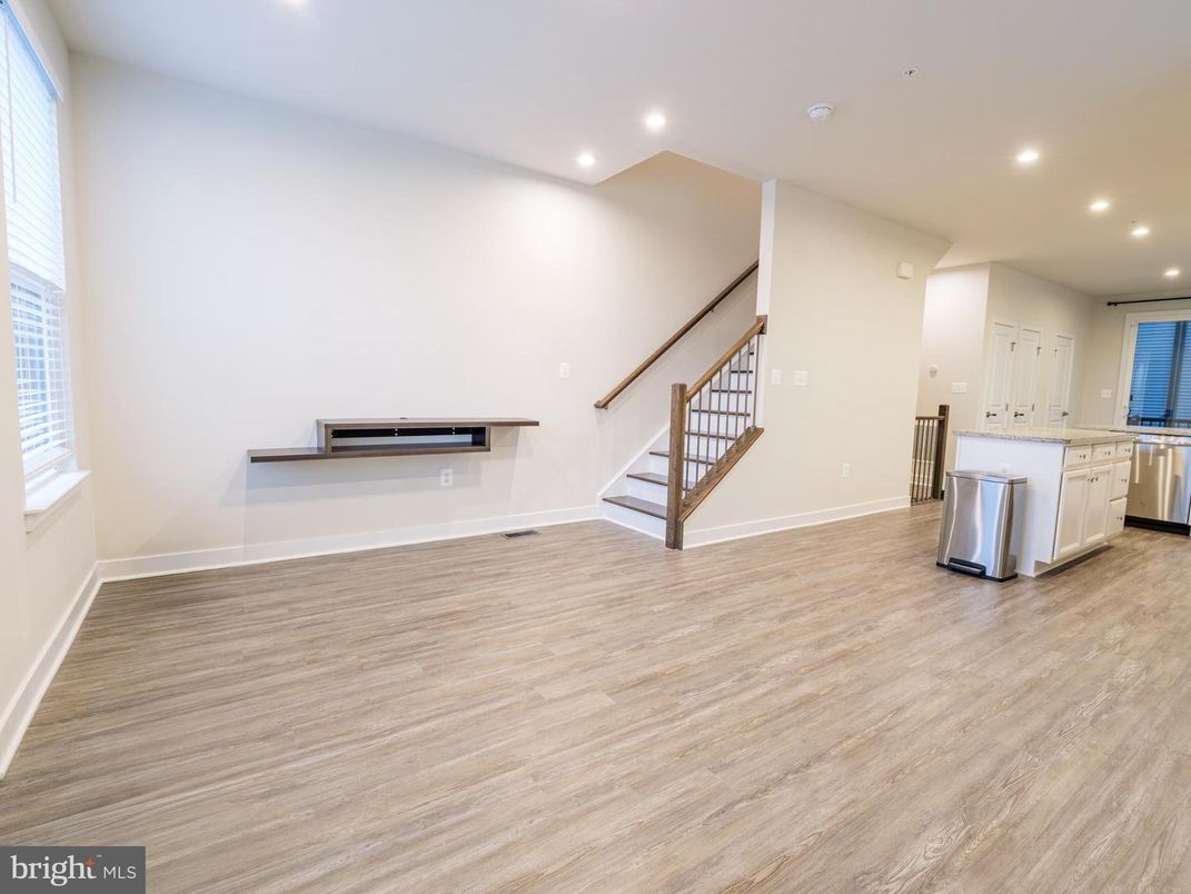 Empty room, Interior, Kitchen, Recessed Lighting, Stainless Steel Appliances, Wood Texture Flooring