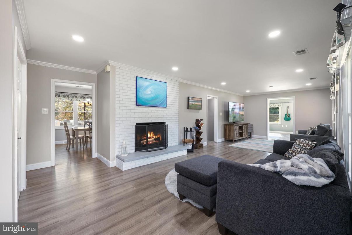 Dining room, Fireplace, Interior, Living room, Recessed Lighting, Wood Texture Flooring