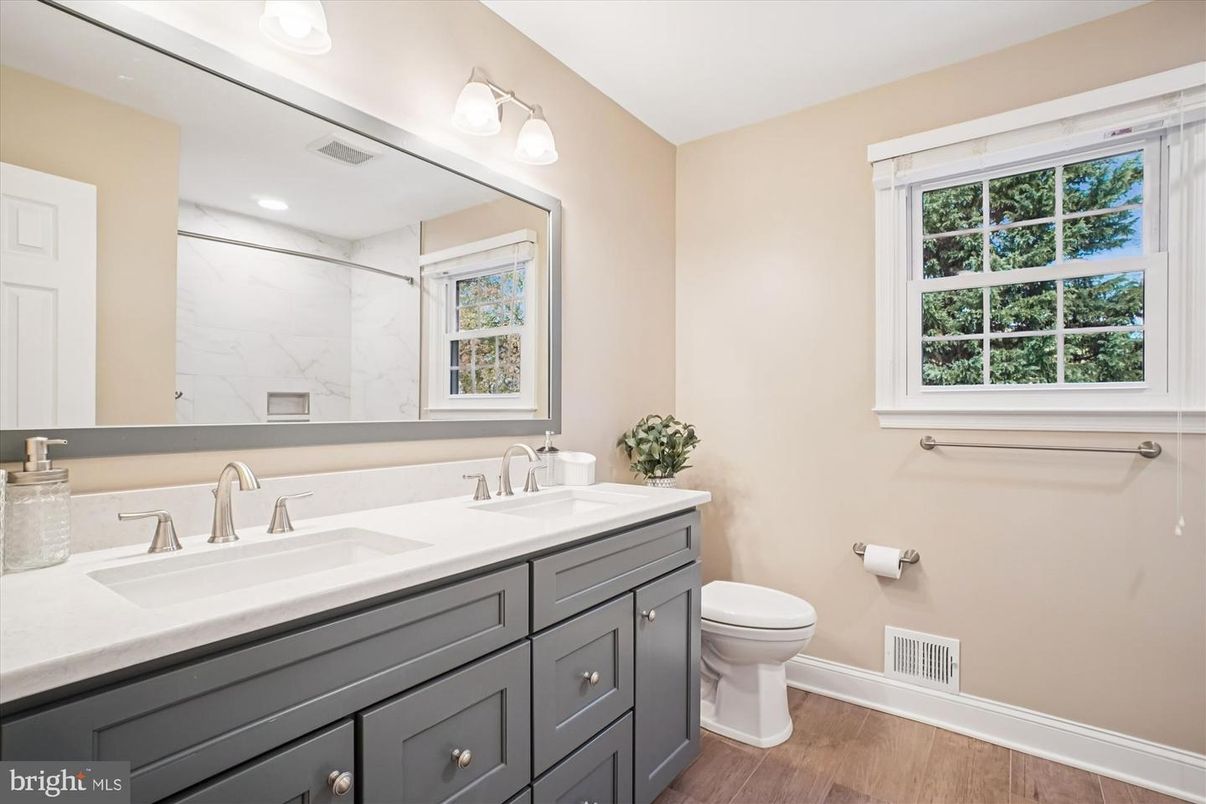 Bathroom, Dual Sink Vanities, Interior, Marble Walls, Recessed Lighting, Wood Texture Flooring