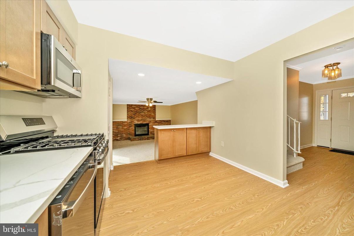 Fireplace, Interior, Kitchen, Recessed Lighting, Stainless Steel Appliances, Stone Walls, Wood Texture Flooring