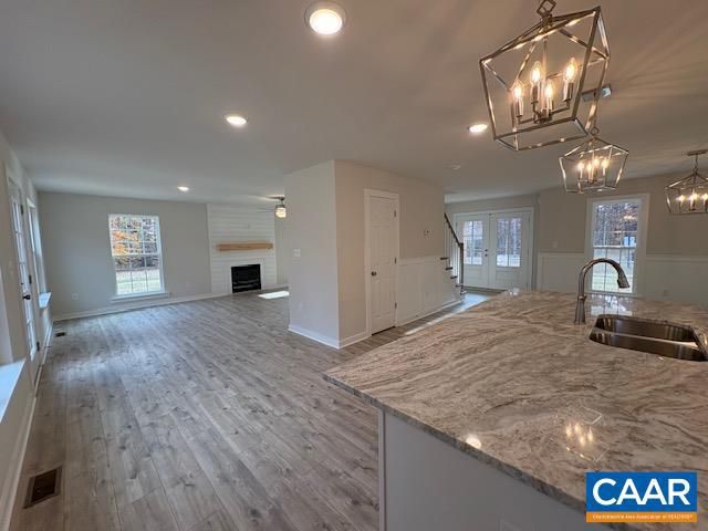 Chandelier, Empty room, Fireplace, Interior, Kitchen, Pendant Lights, Recessed Lighting, Wood Texture Flooring