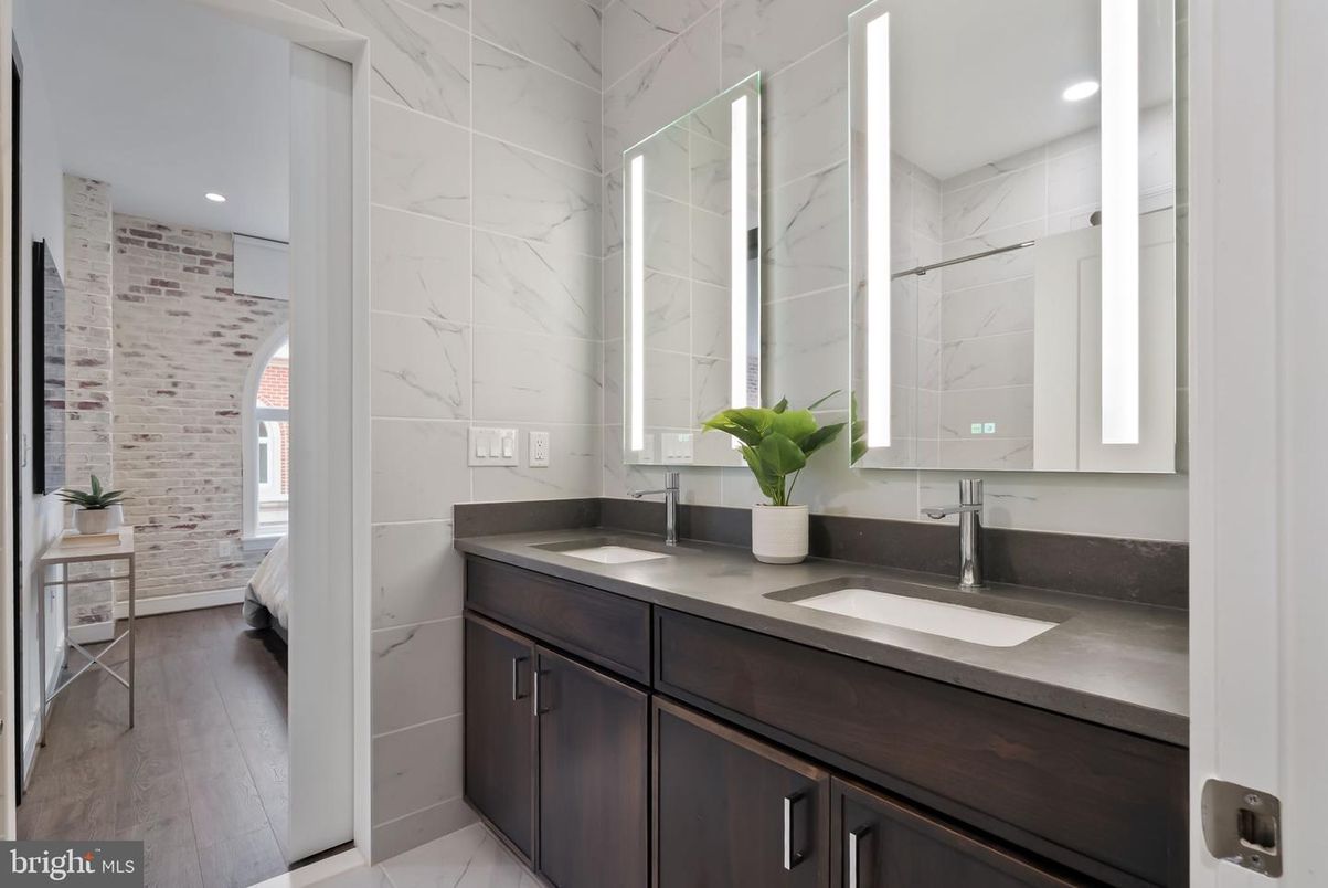 Bathroom, Dual Sink Vanities, Interior, Marble Walls, Recessed Lighting, Wood Texture Flooring
