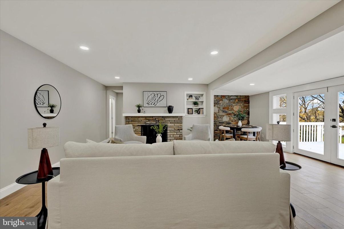 Dining room, Fireplace, Interior, Living room, Recessed Lighting, Stone Walls, Wood Texture Flooring