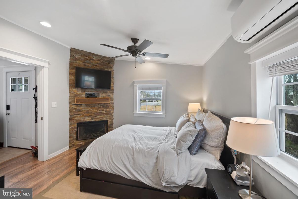 Bedroom, Fireplace, Interior, Recessed Lighting, Stone Walls, Wood Texture Flooring