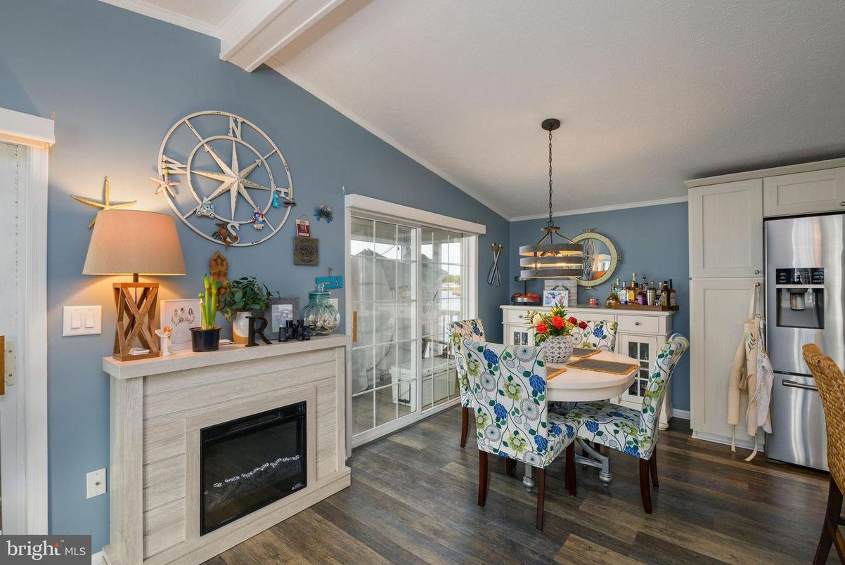 Dining room, Fireplace, Interior, Kitchen, Pendant Lights, Stainless Steel Appliances, Wood Texture Flooring