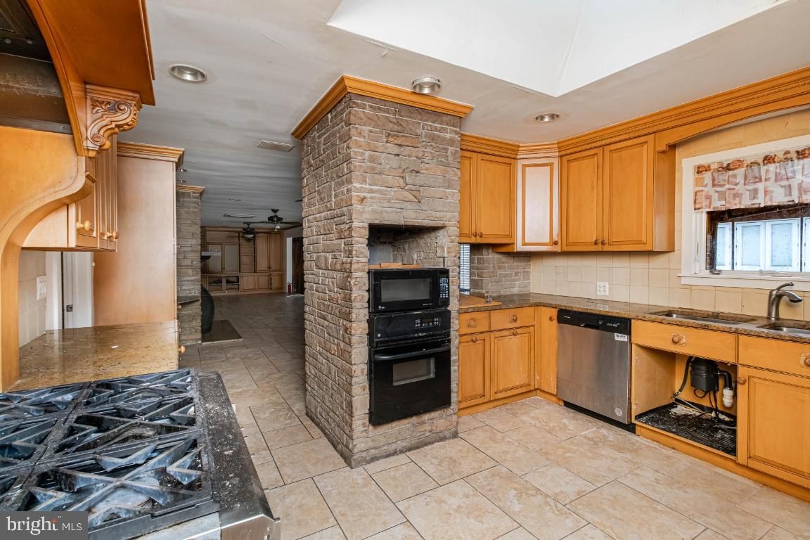 Fireplace, Interior, Kitchen, Recessed Lighting, Stainless Steel Appliances, Stone Walls