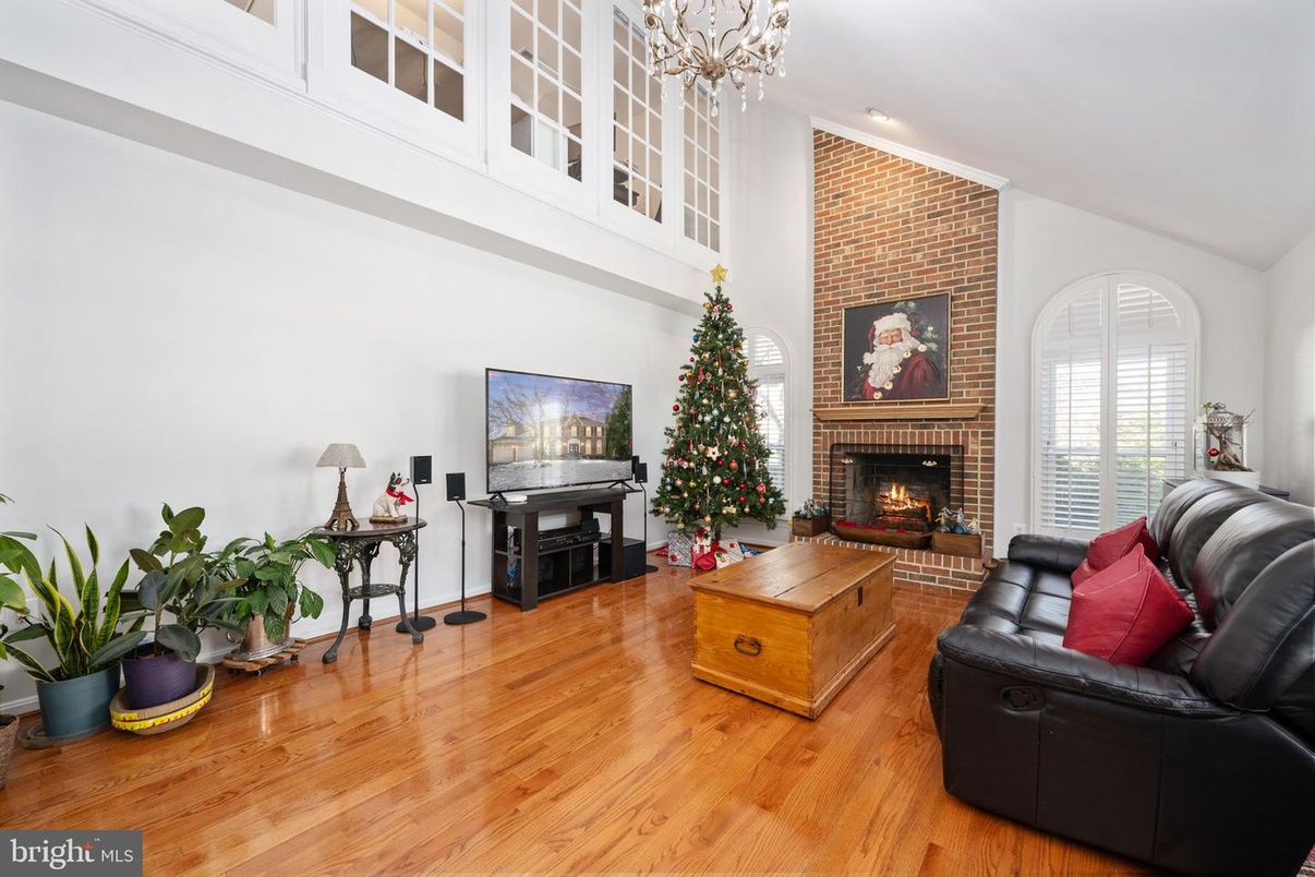 Chandelier, Fireplace, Interior, Living room, Recessed Lighting, Stone Walls, Wood Texture Flooring