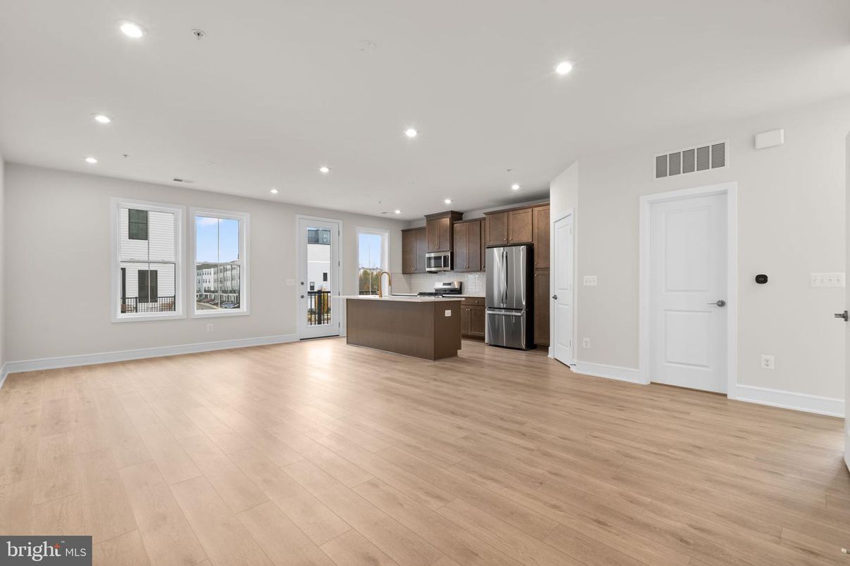 Empty room, Interior, Kitchen, Recessed Lighting, Stainless Steel Appliances, Wood Texture Flooring